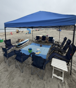 Beach canopy rental with chairs, towels, and cooler at Pacific Beach, San Diego.