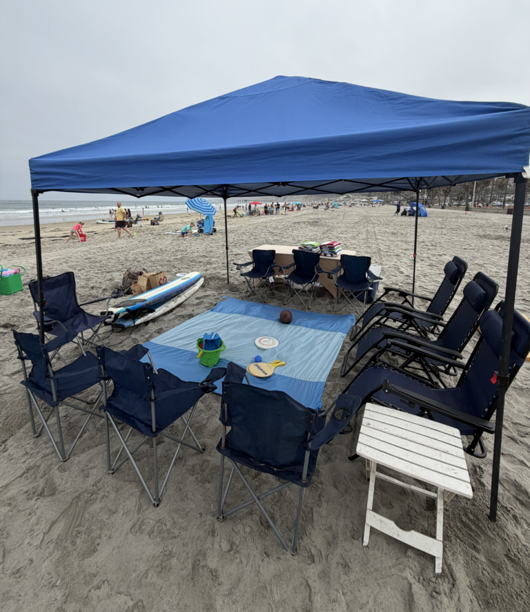 Beach canopy rental with chairs, towels, and cooler at Pacific Beach, San Diego.