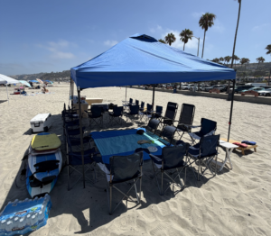 Beach canopy providing shade with comfortable seating and beach accessories along the San Diego shoreline.