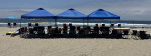 Canopy, chairs, towels, and beach essentials waiting for guests at Pacific Beach.